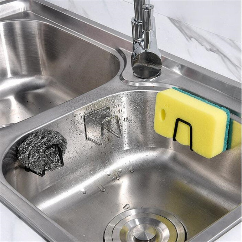 https://www.kitchenswags.com/cdn/shop/products/Kitchen-Stainless-Steel-Sink-Sponges-Holder-Self-Adhesive-Drain-Drying-Rack-Kitchen-Wall-Hooks-Accessories-Storage.jpg?v=1667978712